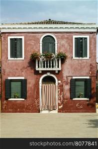 Bright red color house in Burano, Venice