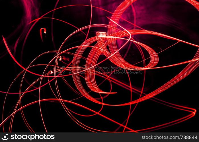 Bright red spiral patterns from light strips on a black background. Bright spiral patterns from light strips on a black background