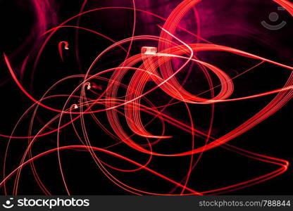 Bright red spiral patterns from light strips on a black background. Bright spiral patterns from light strips on a black background