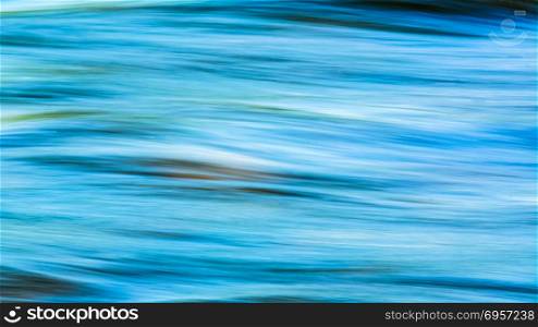 Bright sea green water surface defocused background. Blue water blurred texture.. Bright sea green water surface defocused background