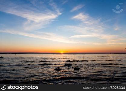 Bright sky and water at sunset over Baltic sea of Tallinn, Estonia