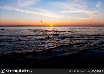 Bright sky and water at sunset over Baltic sea of Tallinn, Estonia