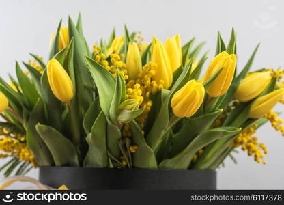 Bright spring bouquet of tulips and mimosa flowers. Mother&amp;#39;s Day or Easter theme.