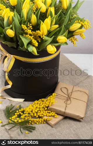 Bright spring bouquet of tulips and mimosa flowers. Mother&amp;#39;s Day or Easter theme.
