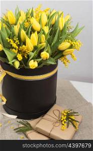Bright spring bouquet of tulips and mimosa flowers. Mother&rsquo;s Day or Easter theme.