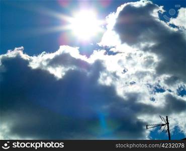 bright sun above fluffy clouds