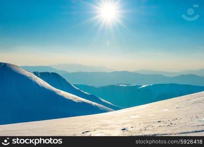 Bright sun in winter mountains covered with snow