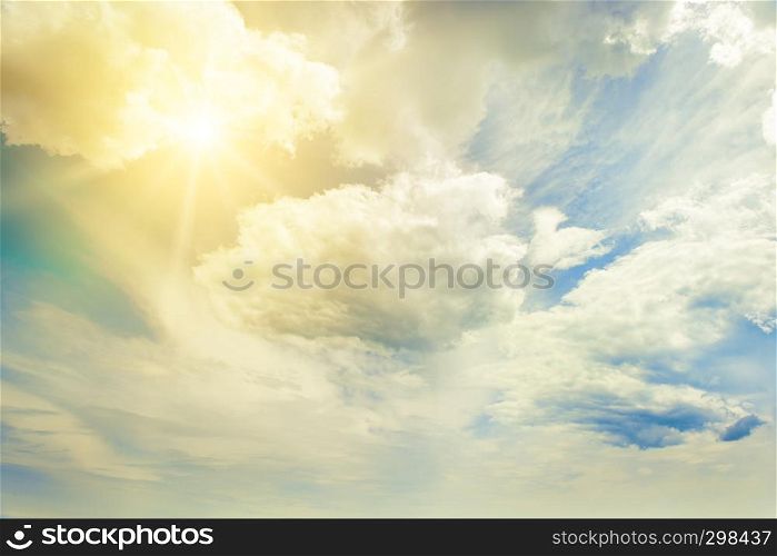Bright sun on blue sky with beautiful white clouds.