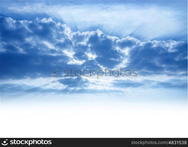 Bright sunrays make their way through cumulonimbus clouds, sky background with copy space, beautiful heaven, atmosphere concept