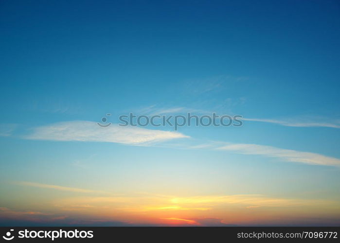 Bright sunset against blue sky and clouds