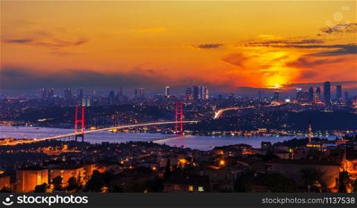 Bright sunset and the Boshporus Bridge in Istanbul, view from the Asian side, Turkey.