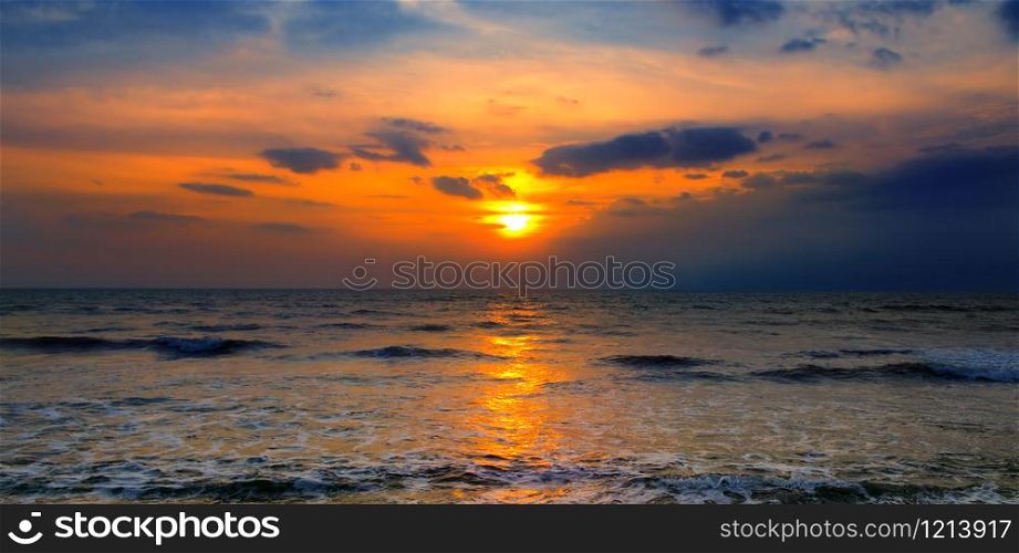 Bright sunset over the sea. The concept is travel. Wide photo.