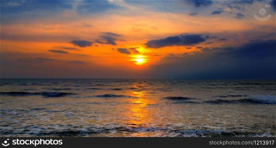 Bright sunset over the sea. The concept is travel. Wide photo.