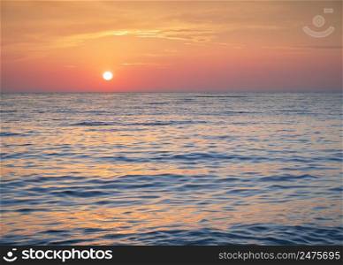 Bright sunset with yellow sun. Nature seascape.