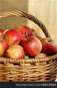 Bright tasty ripe apples in a basket, close-up