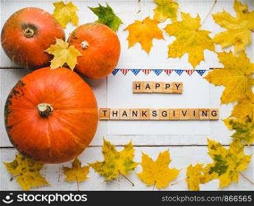 Bright Thanksgiving greeting card with ripe pumpkins, autumn leaves and and inscription. Preparing for the holidays. Congratulations for loved ones, relatives, friends and colleagues. Bright Thanksgiving greeting card with ripe pumpkins