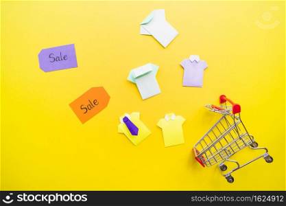 bright toy paper shirts near shopping trolley sale tags