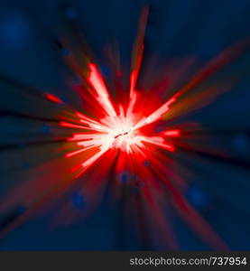 Bright vibrant abstract blast or explosion on a deep blue background with radiating red rays from a bright centre over a deep blue background in square format