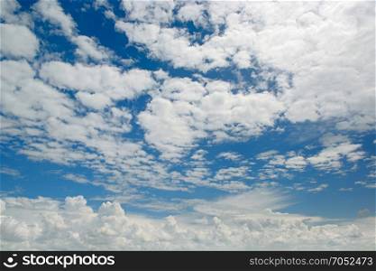 Bright white clouds on a background of dark blue sky.