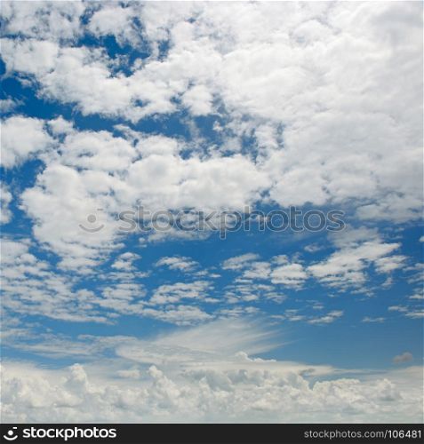 Bright white clouds on background of dark blue sky.