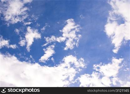 Bright white clouds with a deep blue sky background