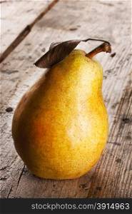 Bright yellow juicy pear on wooden background