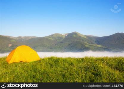 bright yellow tourist tent in the mountains nature