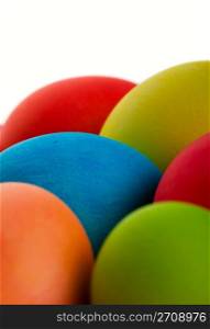 Brightly colored Easter eggs closeup. Shot on white background.