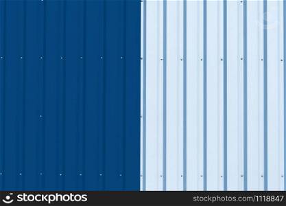Brightly colored industrial warehouse exterior wall as background. Color of the year 2020 classic blue toned