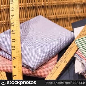 Brightly Colored Swatches in Wicker Basket with Wooden Rulers, Measuring Tape and Scissors