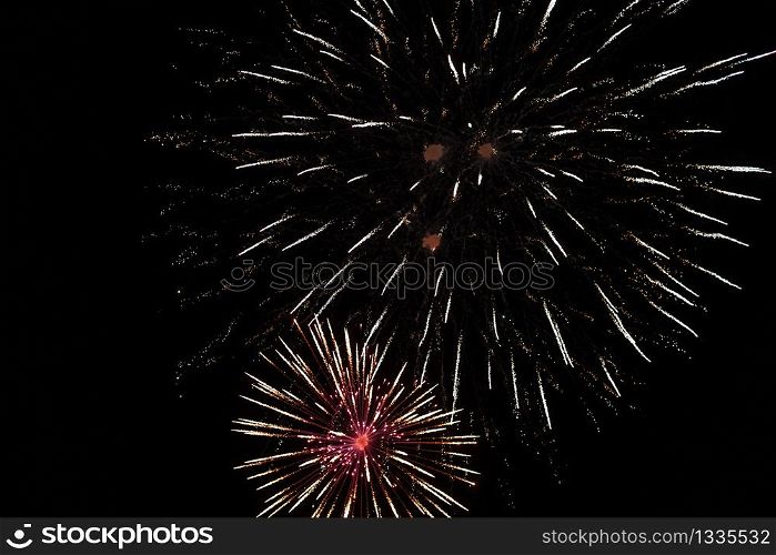 Brightly colorful fireworks and salute of various colors in the night sky background. selective focus.. Brightly colorful fireworks and salute of various colors in the night sky background. selective focus