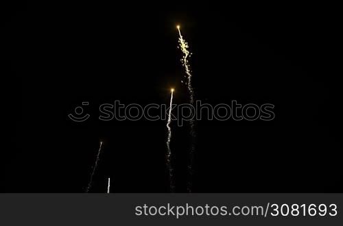 Brightly colorful fireworks for New Year and other events celebration on dark background.