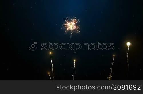Brightly colorful fireworks for New Year and other events celebration on dark blue background.