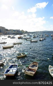 Brightly painted Maltese boats on blue water in summer, Malta.