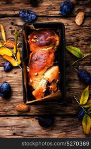 Brioche with plum. Brioche with autumn plum in the baking tray
