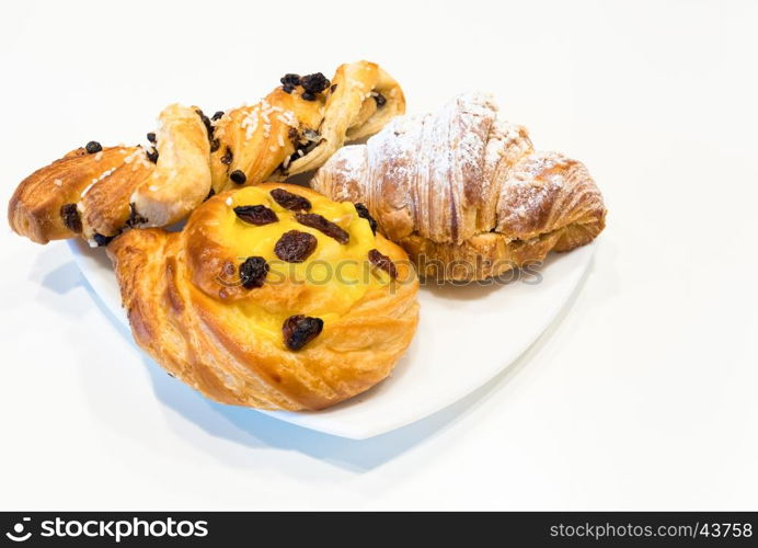 Brioches on white plate,italian breakfast, white background.