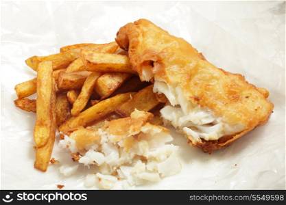 "British "chip shop" style fried cod in batter with chips (french fries) in a wrapping of greaseproof paper. Shot with a tilt-shift lens for maximum depth of field."