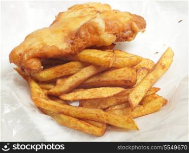 "British "chip shop" style fried cod in batter with chips (french fries) in a wrapping of greaseproof paper."