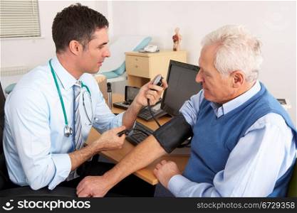 British doctor taking senior man&acute;s blood pressure