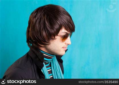 british indie pop rock look retro hip young man with sunglasses on blue