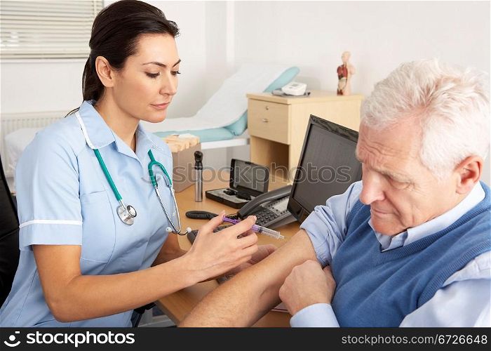 British nurse giving injection to senior man