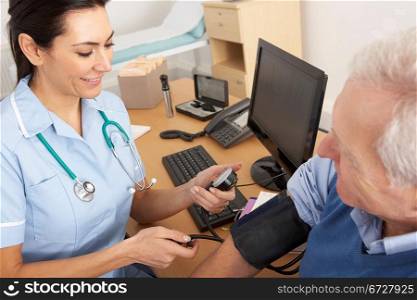 British nurse taking senior man&acute;s blood pressure