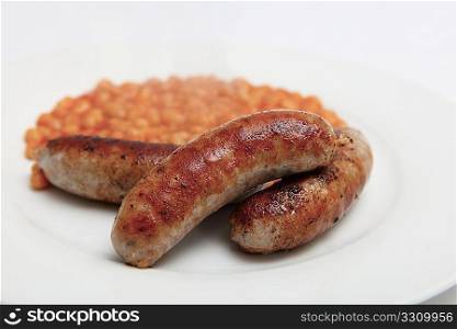 British pork sausages and baked beans on a white plate