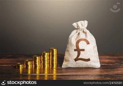 British pound sterling money bag and increasing stacks of coins. Rise in profits, budget fees. Investments. Raise incomes, increase salaries. Financial success. Bonus. Economic growth, GDP. Savings