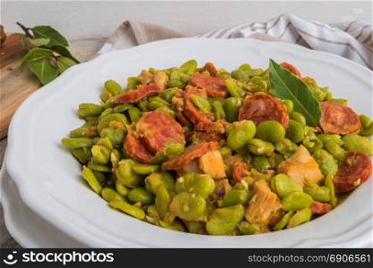 Broad bean with chorizo on vintage background. Typical portuguese food