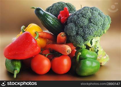 broccoli, Bomatoes, carrots and cucumber lie on table