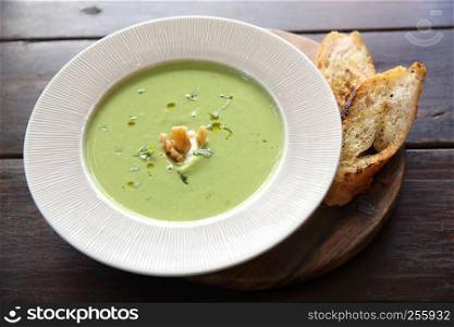 broccoli cream soup on wooden table