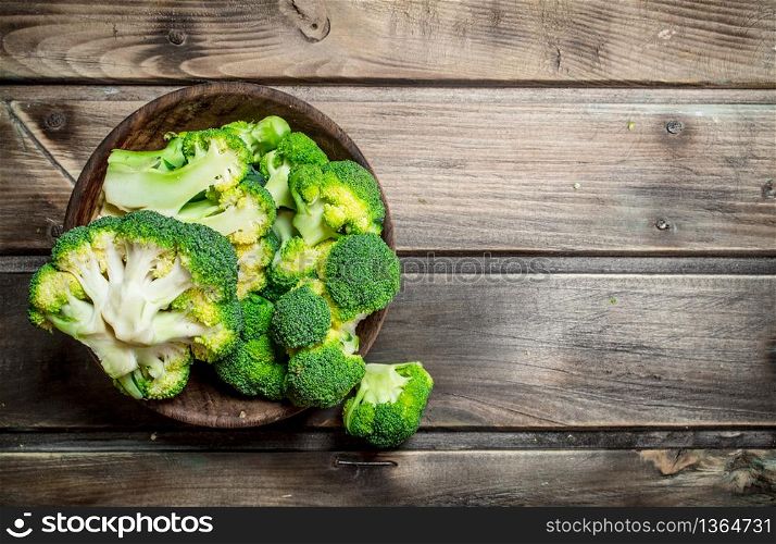 Broccoli in a bowl. On a wooden background.. Broccoli in a bowl.