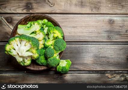 Broccoli in a bowl. On a wooden background.. Broccoli in a bowl.