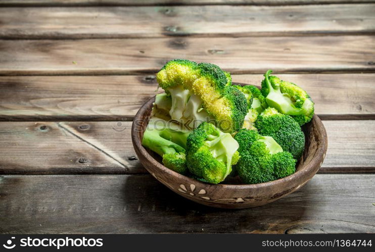 Broccoli in a bowl. On a wooden background.. Broccoli in a bowl.